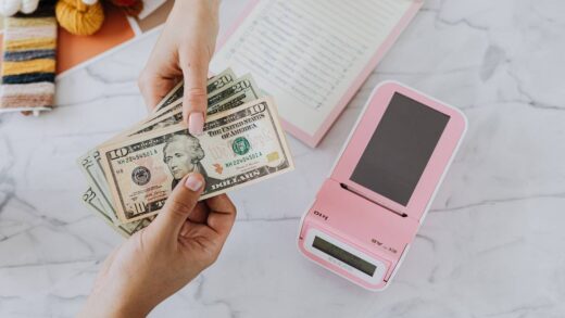 two person holding dollar bills